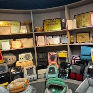 Wholesale pet carrier backpacks and travel bags display in a verified factory showroom with industry awards and certificates for global sourcing.